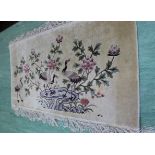 A Chinese silk hand knotted rug decorated with cranes,