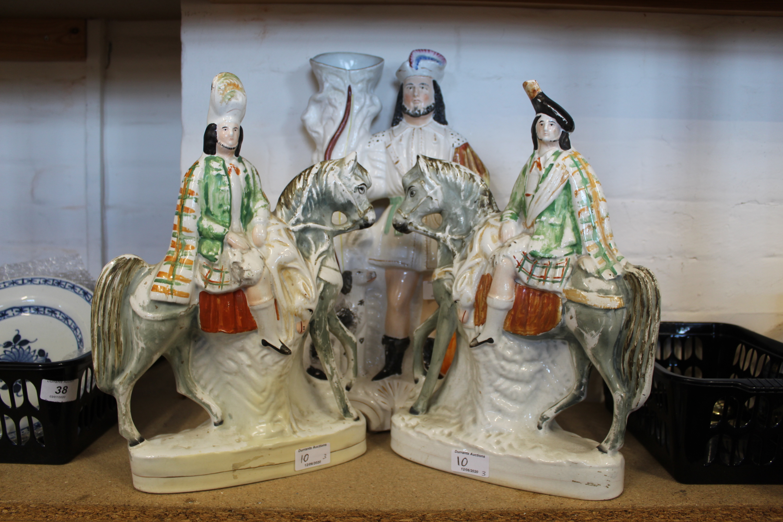Three large Staffordshire Highland flat back figurines of a hunter with hound and two Scots on