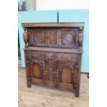 A Jacobean style carved oak court cupboard