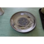 A Studio Pottery dish on a pale grey ground with blue geometric circular design to centre by Andrew