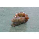 A carved Chinese Celadon jade brush washer of a mythical beast,