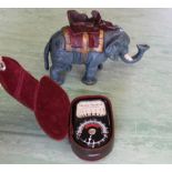A cast metal elephant money box together with a vintage camera light meter