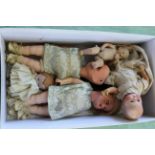Five various sized bisque headed dolls,