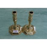 A pair of Georgian style brass candlesticks