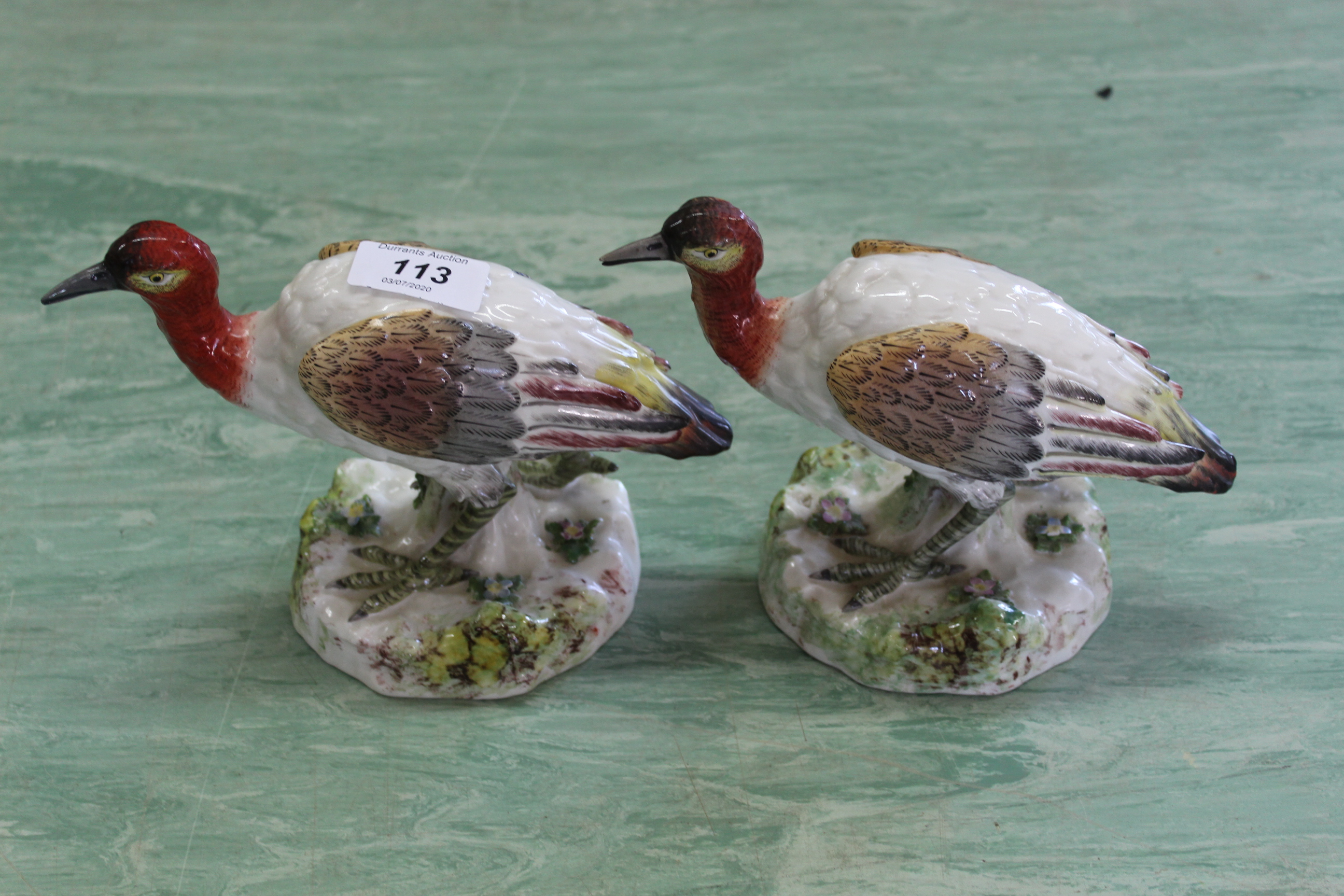 A pair of antique Staffordshire style birds