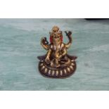 A small Tibetan gilt copper figure of a seated armed Ganesh,
