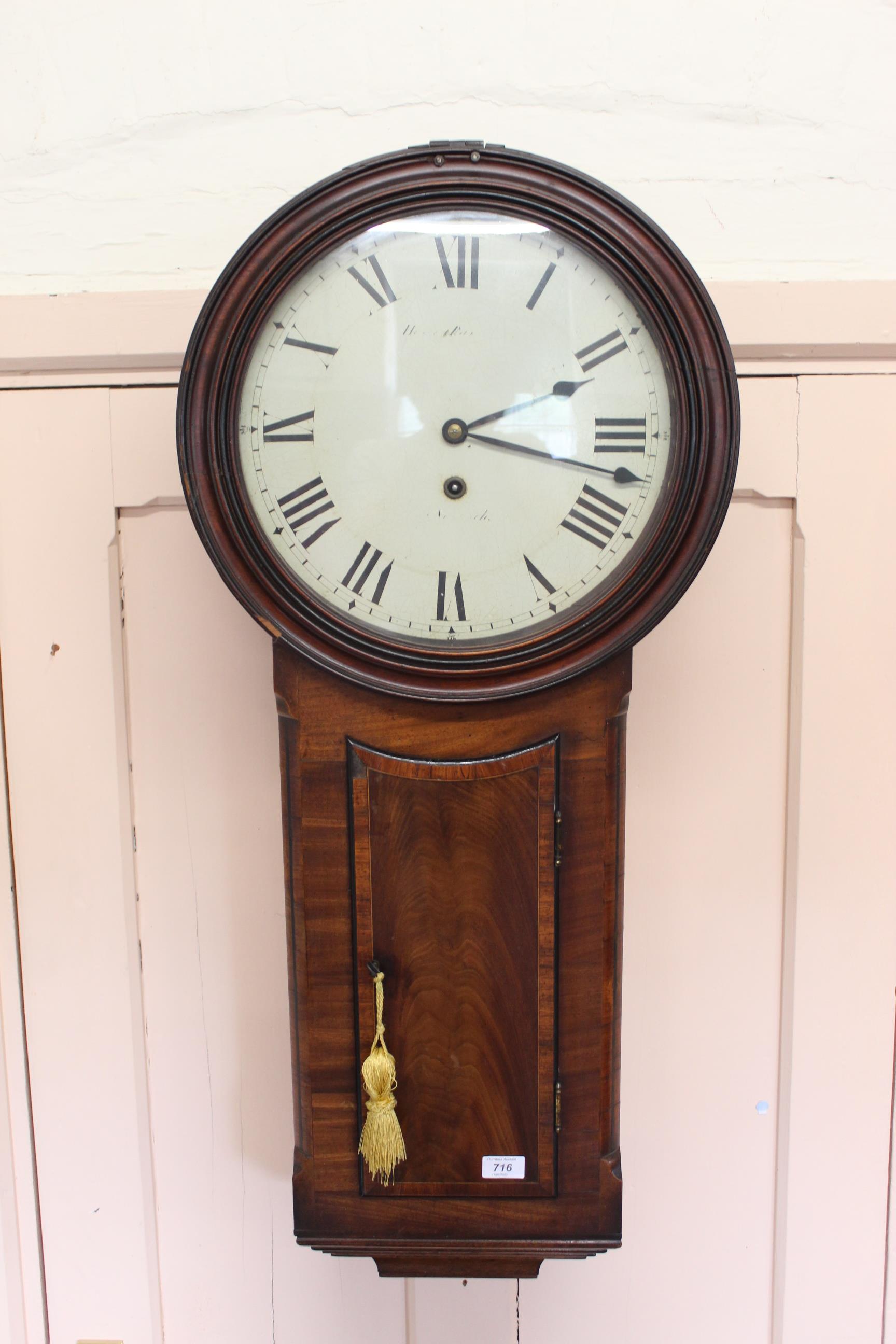 An early 19th Century mahogany trunk dial wall clock with well figured veneers to the case,