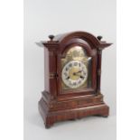 An Edwardian walnut cased mantel clock