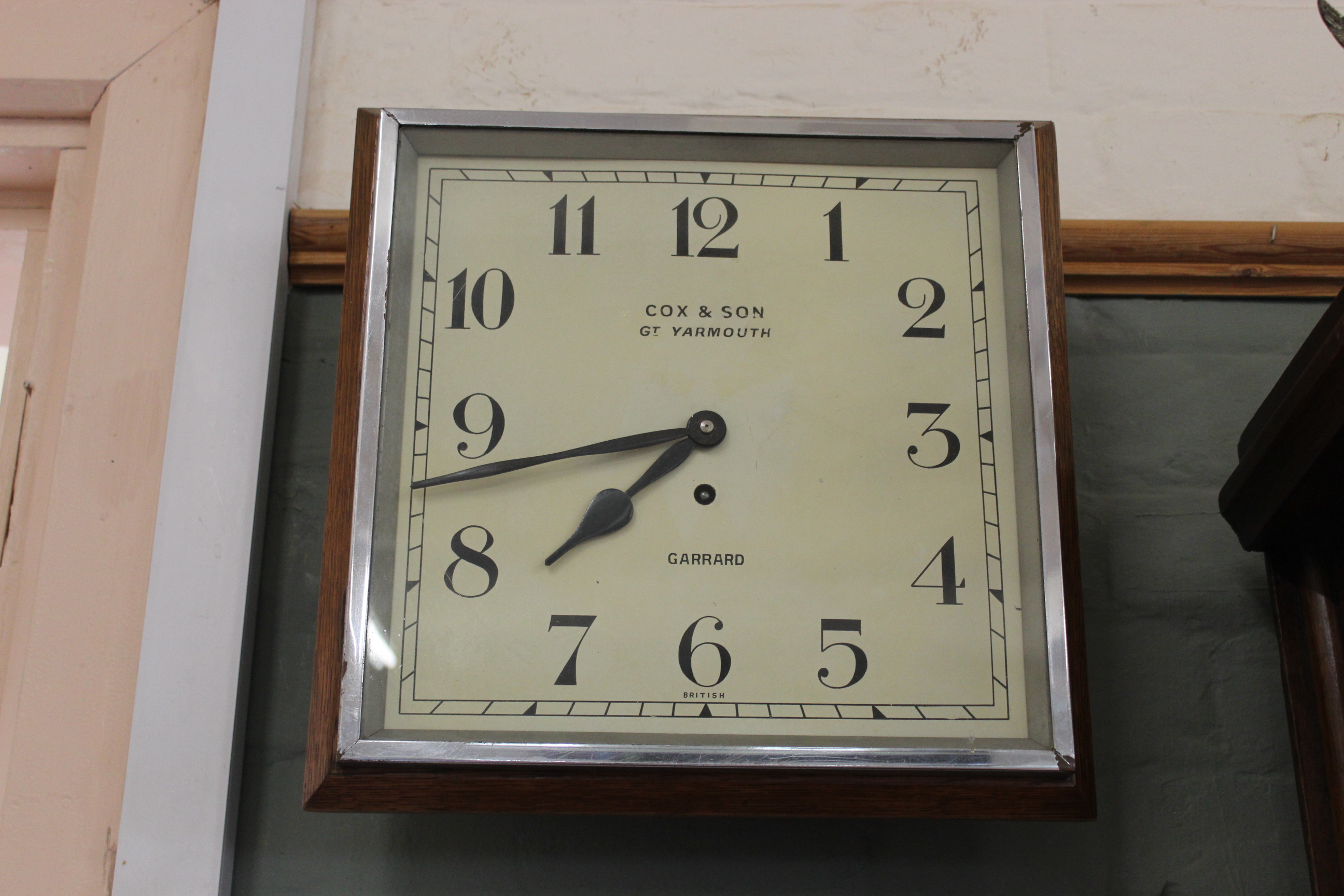 A 1930's chrome and oak Garrard wall clock,