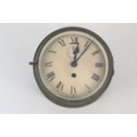 A heavily tarnished brass ships clock, faintly marked 'Felix Martin,