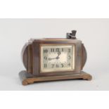 A Ronson 8 day clock with touch tip lighter, Art Deco style case in bronze/copper colour,