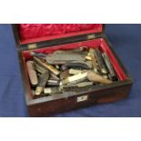 A large collection of various pocket knives within a Victorian rosewood box (box as found)