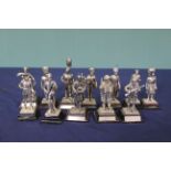 Twelve various metal military figures on wooden plinths,