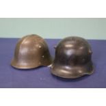 A German WWI era helmet, shell only (as found) with a Bulgarian helmet M36,