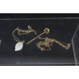 Three small 9ct gold chains, one with mother of pearl pendant plus a 9ct gold horseshoe stick pin,