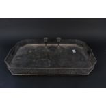 A large rectangular plated tray with pierced gallery edge on four feet together with a pair of