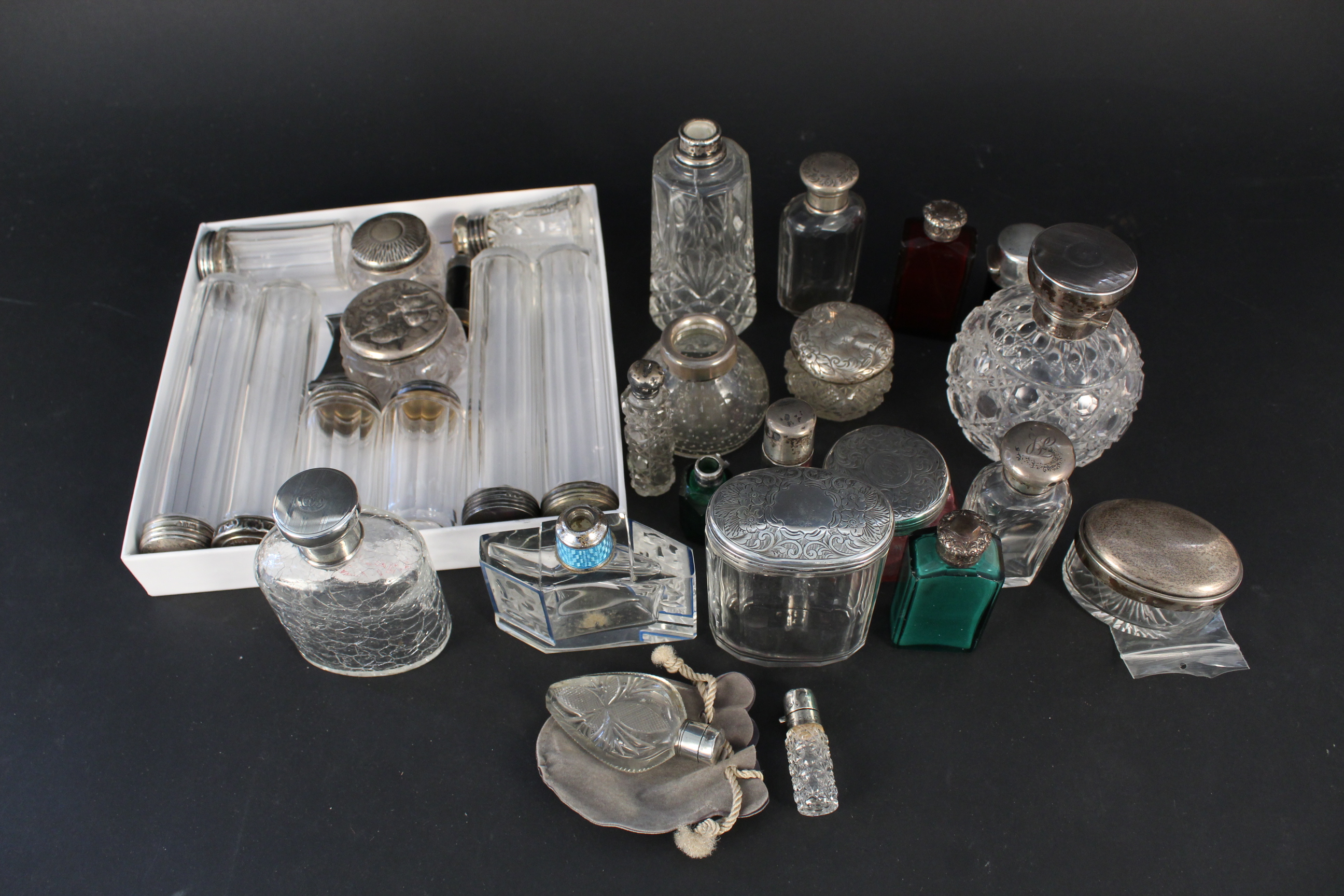 A large collection of silver and white metal lidded/mounted jars, bottles,