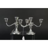 A pair of (filled) sterling silver three branch candelabra,