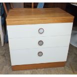 A 1970's white fronted bedside chest of three drawers