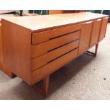 A vintage retro mid 20th Century Danish teak wood sideboard by Beautility with three cupboards and