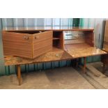 A 1960's sideboard/cocktail cabinet with mock burr walnut panels, folding doors,