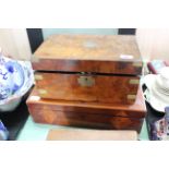 A burr walnut and brass bound 19th Century writing slope containing ink bottles and secret drawer