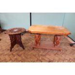 A mahogany coffee table on elephant supports and a folding carved table