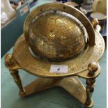 A solid brass mounted globe with signs of the Zodiac to edge,