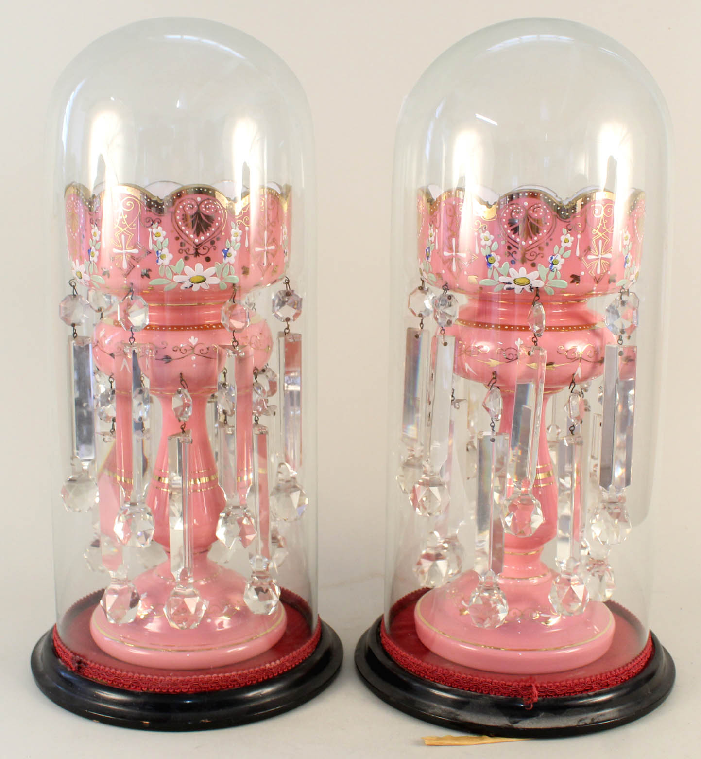 A pair of Victorian pink glass lustres with enamel decoration and cut clear crystal droplets housed