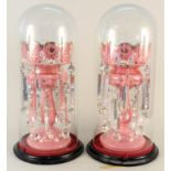 A pair of Victorian pink glass lustres with enamel decoration and cut clear crystal droplets housed