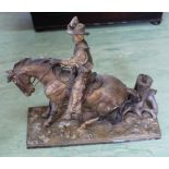 A vintage spelter table top touch lighter in the form of a cowboy on horse,