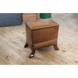 An Arts and Crafts style leatherette and oak lifting top stool