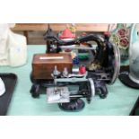 An antique Jones manual sewing machine plus a childs size Singer sewing machine