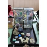 A tray with a selection of crystals in two display cases and some loose plus two stone carved dog