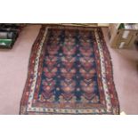 Two Persian rugs (both worn),