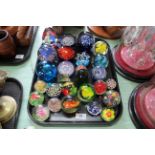 A tray of various size glass paperweights