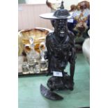 An early 20th Century carved ebony figure of an oriental man with wide brimmed hat (as found),