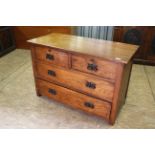 An Edwardian oak four drawer chest