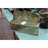 A Dutch hanging brass candle box embossed with Coat of Arms and rural scene,