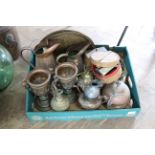 A box of metalware including two copper jugs, a pair of spelter vases,