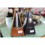 A German made metronome by Maelzel plus a lightwood German metronome (lacking front cover)