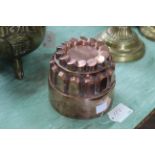 A Victorian circular copper jelly mould of turret form, stamped 21,