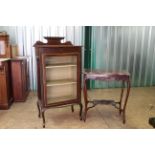 An Edwardian inlaid display cabinet and shaped top two tier table