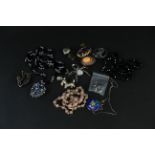 Mixed costume jewellery including pink quartz necklace, brooches including a spider, dogs etc,