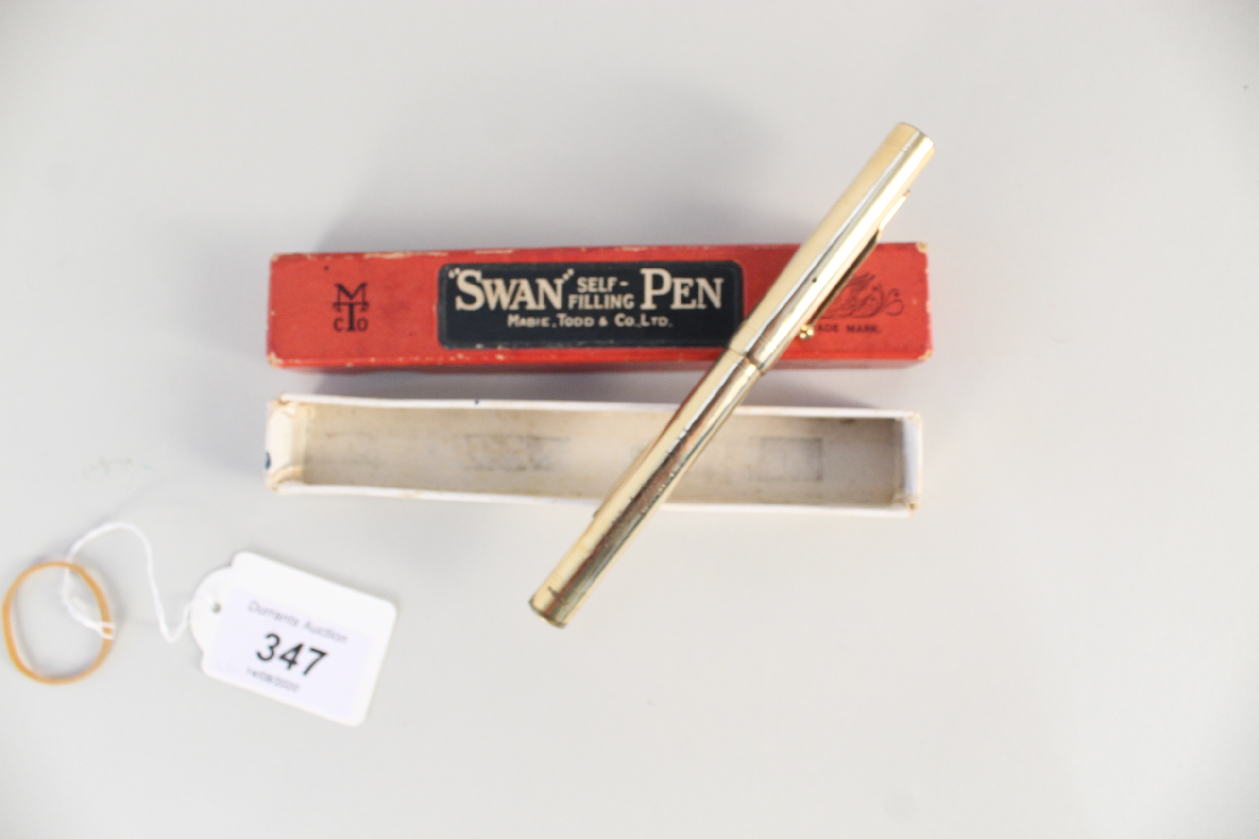 A boxed Swan gold plated self filling pen by Mabie Todd & Co.