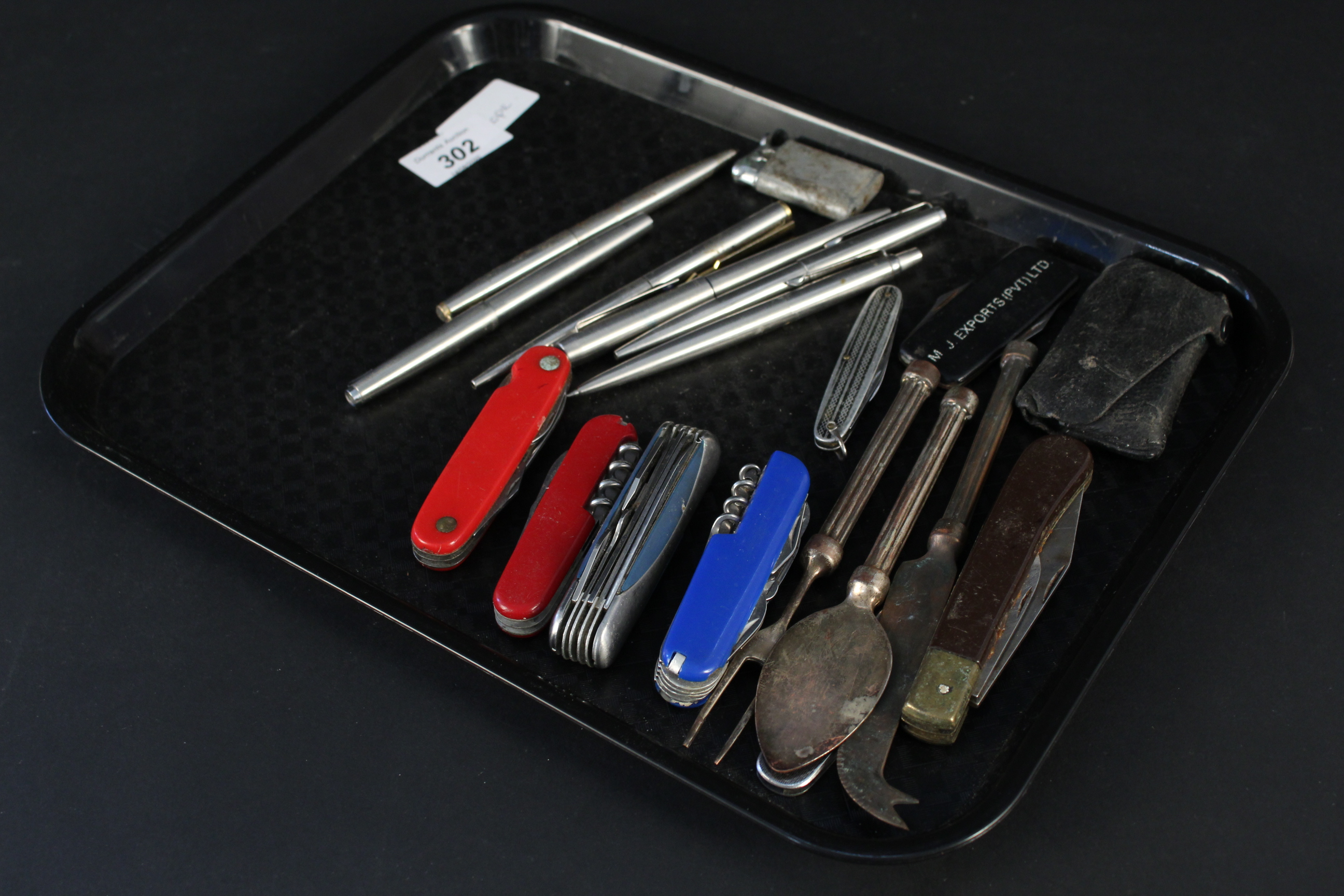 A selection of pens (including Parker pens), folding knives,