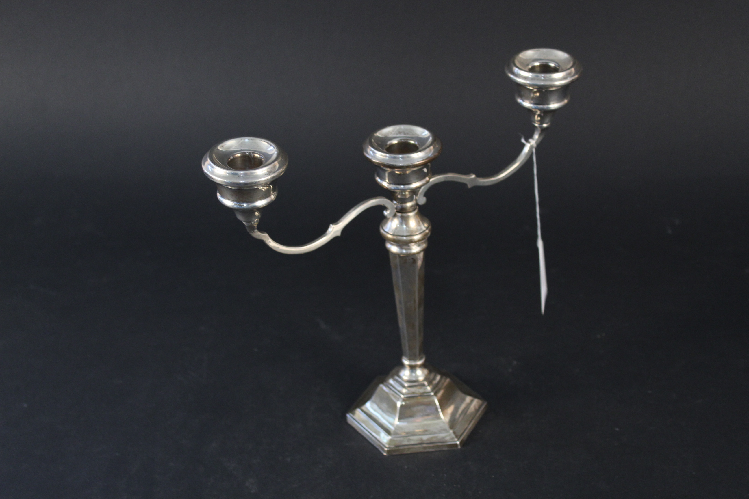 A silver three branch candelabra, hallmarked Birmingham 1976, maker's mark Sanders & MacKenzie,