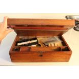 A late 19th/early 20th Century mahogany writing slope with contents including ink pens with