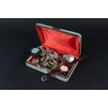 A small jewellery box and contents including a silver necklace,