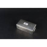 A silver cigarette box with engine turned decoration to lid,